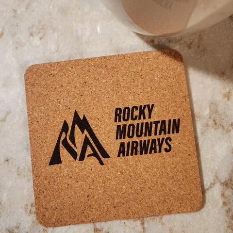 Image of cork coaster with Rocky Mountain AIrways branding impression.