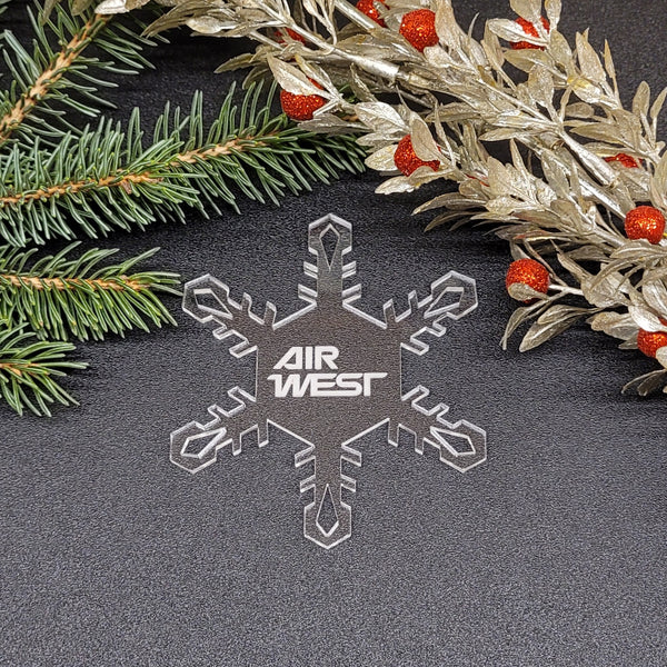 Image of acrylic snowflake ornament with Air West branding impression.