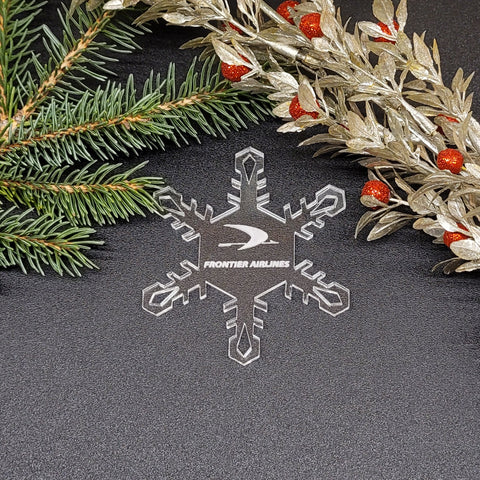 Image of acrylic snowflake ornament with Frontier Airlines branding impression.